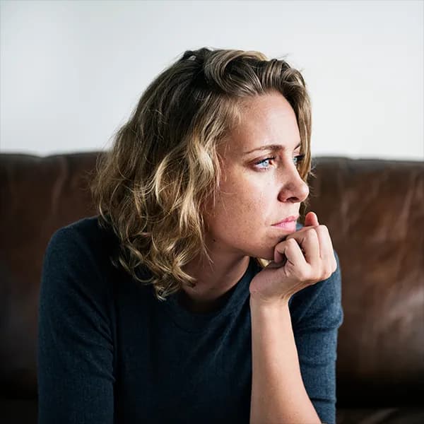 Woman looking out a window thoughtfully