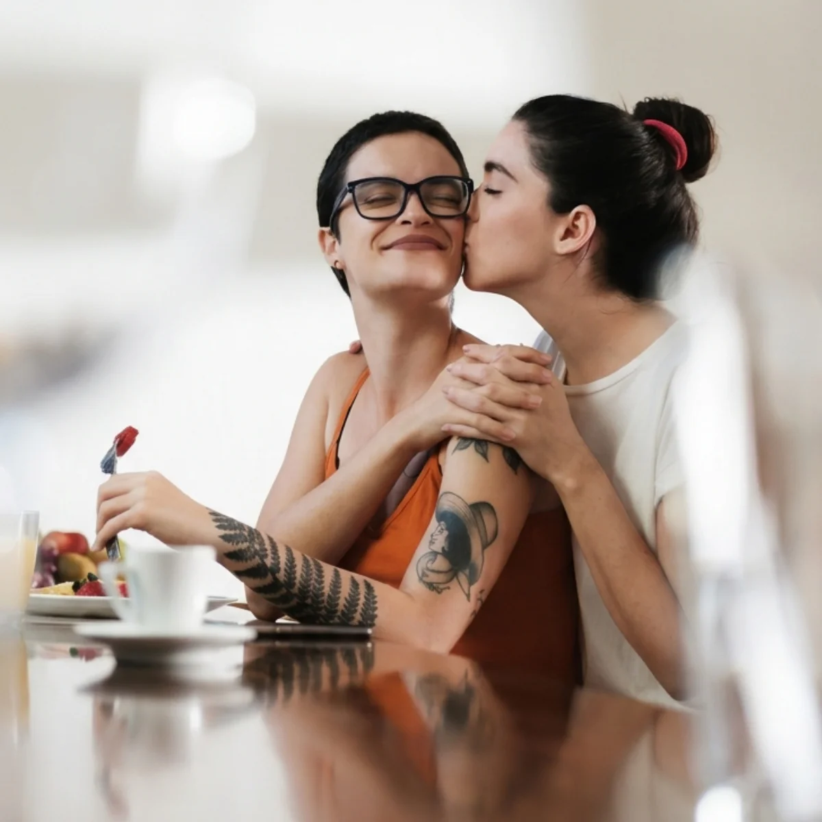 Couple sharing an affectionate, connected moment over breakfast