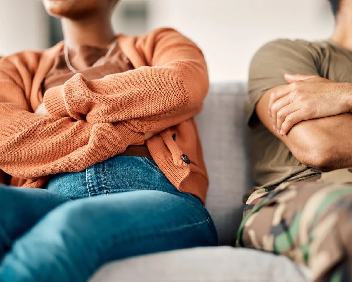 Couple sitting on a sofa in therapy, working through emotional disconnection