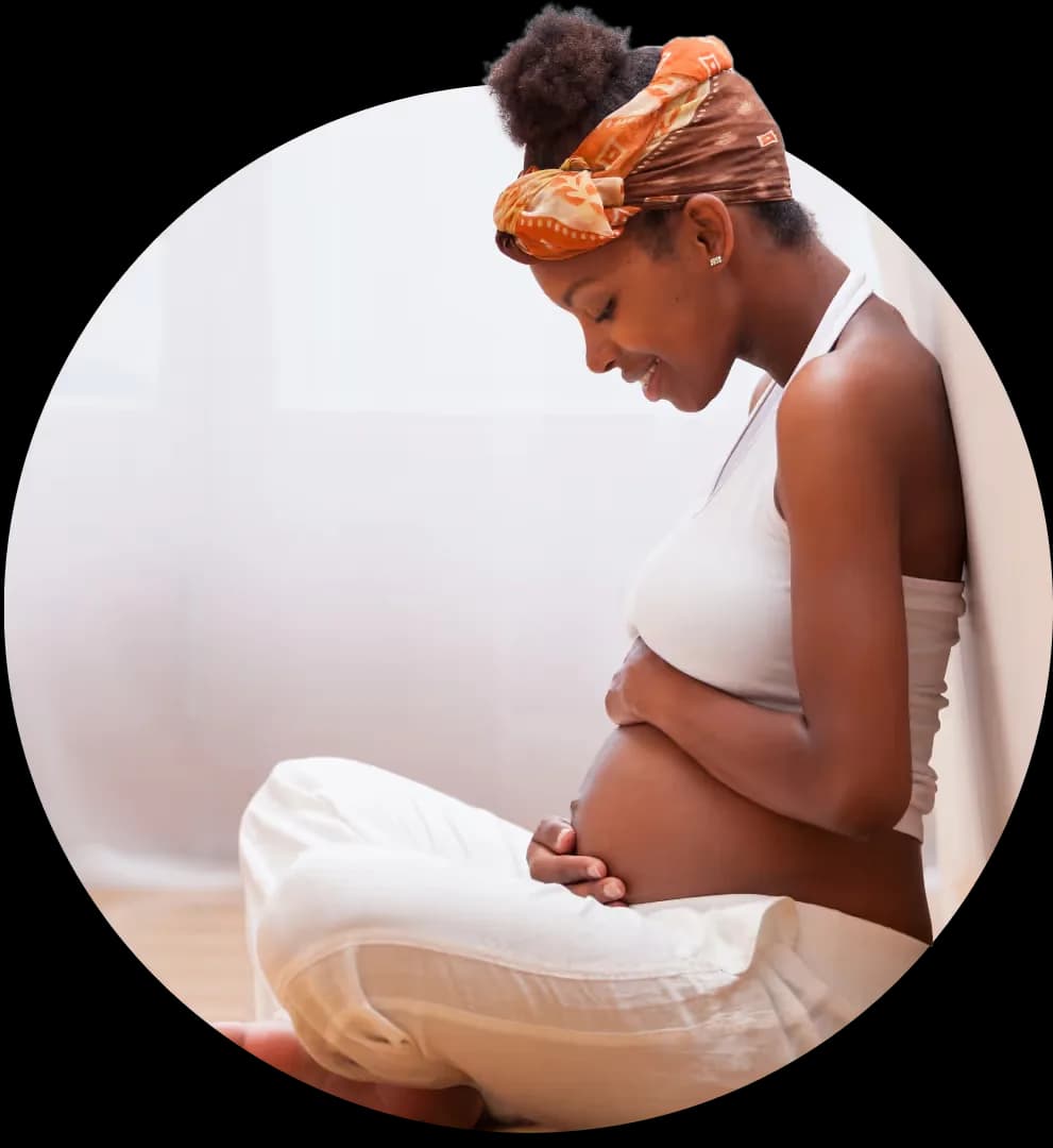 Pregnant woman gently hugging her belly