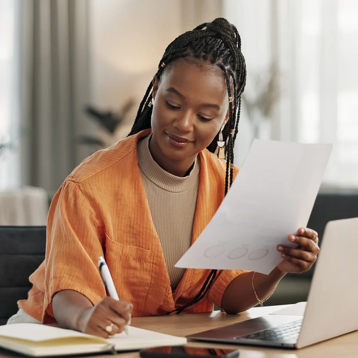 Woman working at her laptop from a home office, focused and engaged
