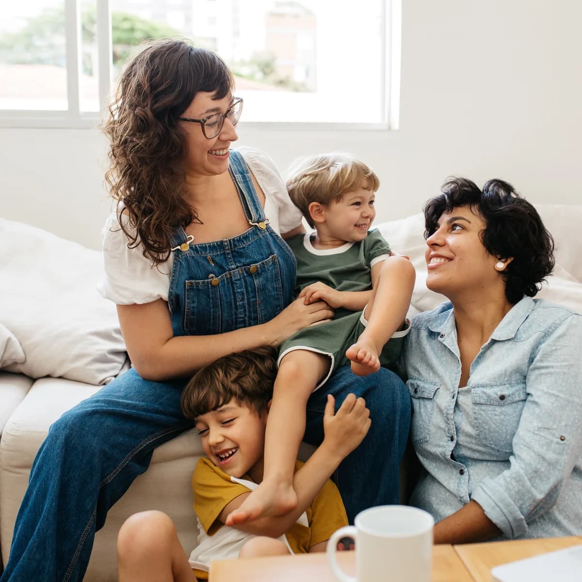 Two mothers and their child sharing a joyful family moment