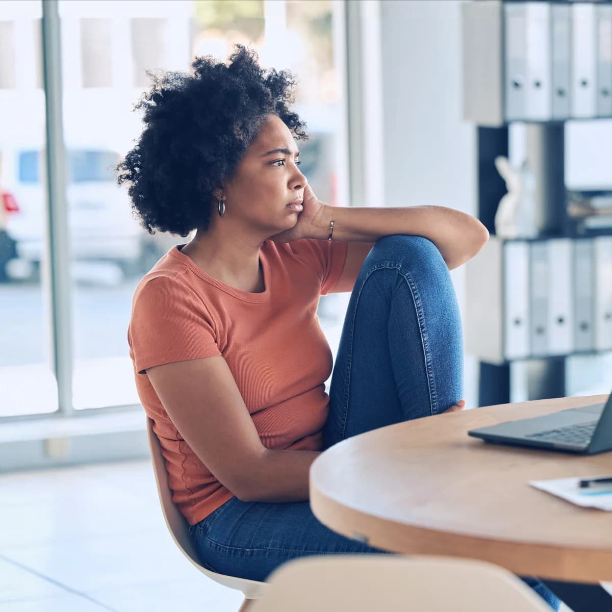 Woman at her laptop, frustrated and exhausted by the pressure of perfectionism