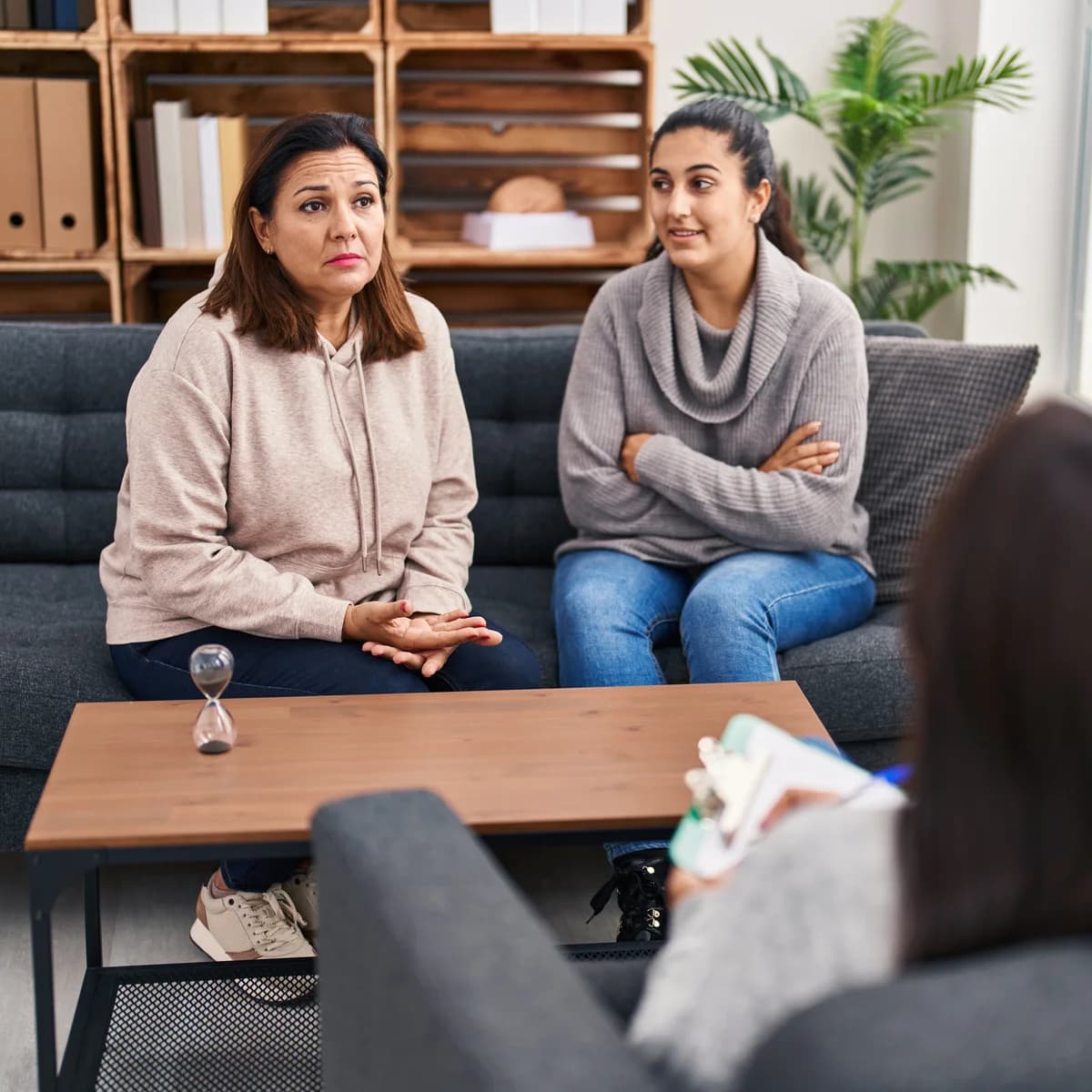 Mother and daughter in a therapy session, working through family dynamics together